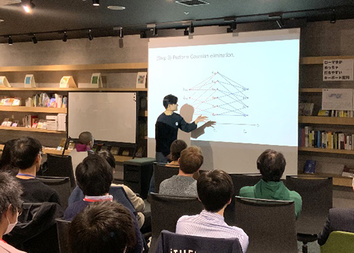  image of Taketo Sano (iTHEMS Special Postdoctoral Researcher) giving presentation