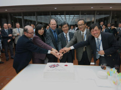 Image of people surrounding the cake