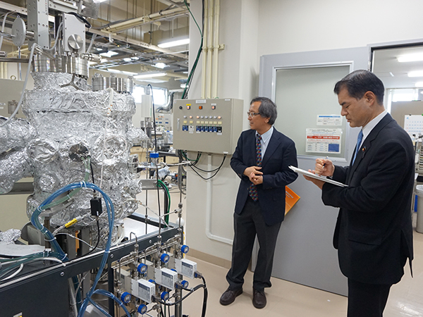 写真:実験室にて十倉センター長(左)から説明を受けられる柴山大臣